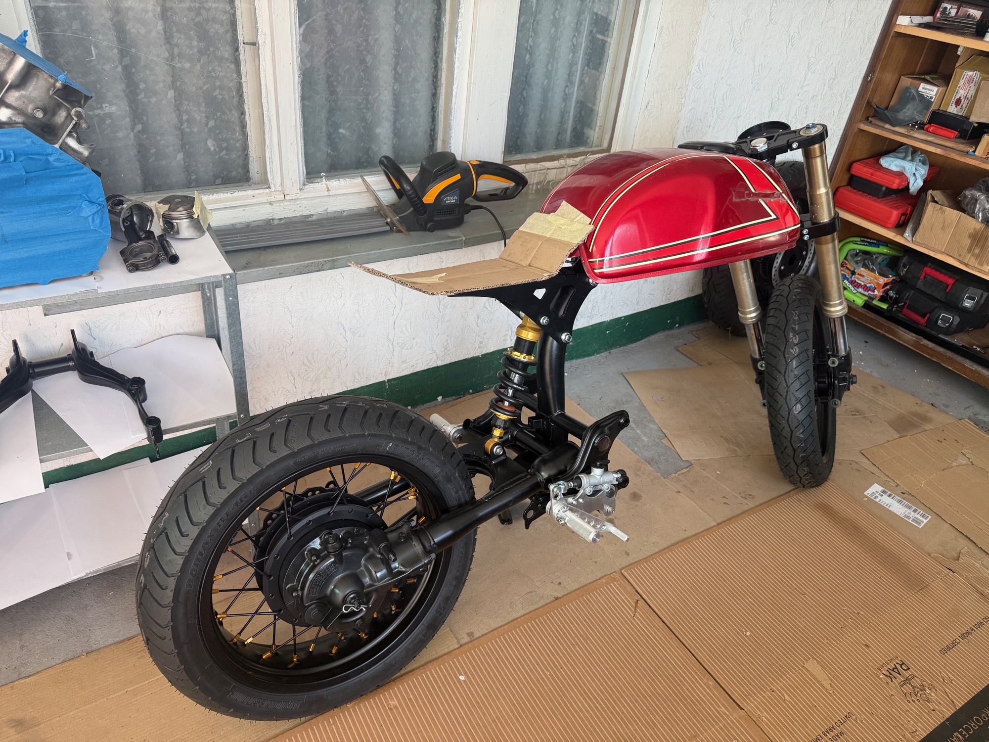 Honda CX500 cafe racer build in the garage, side profile during teardown