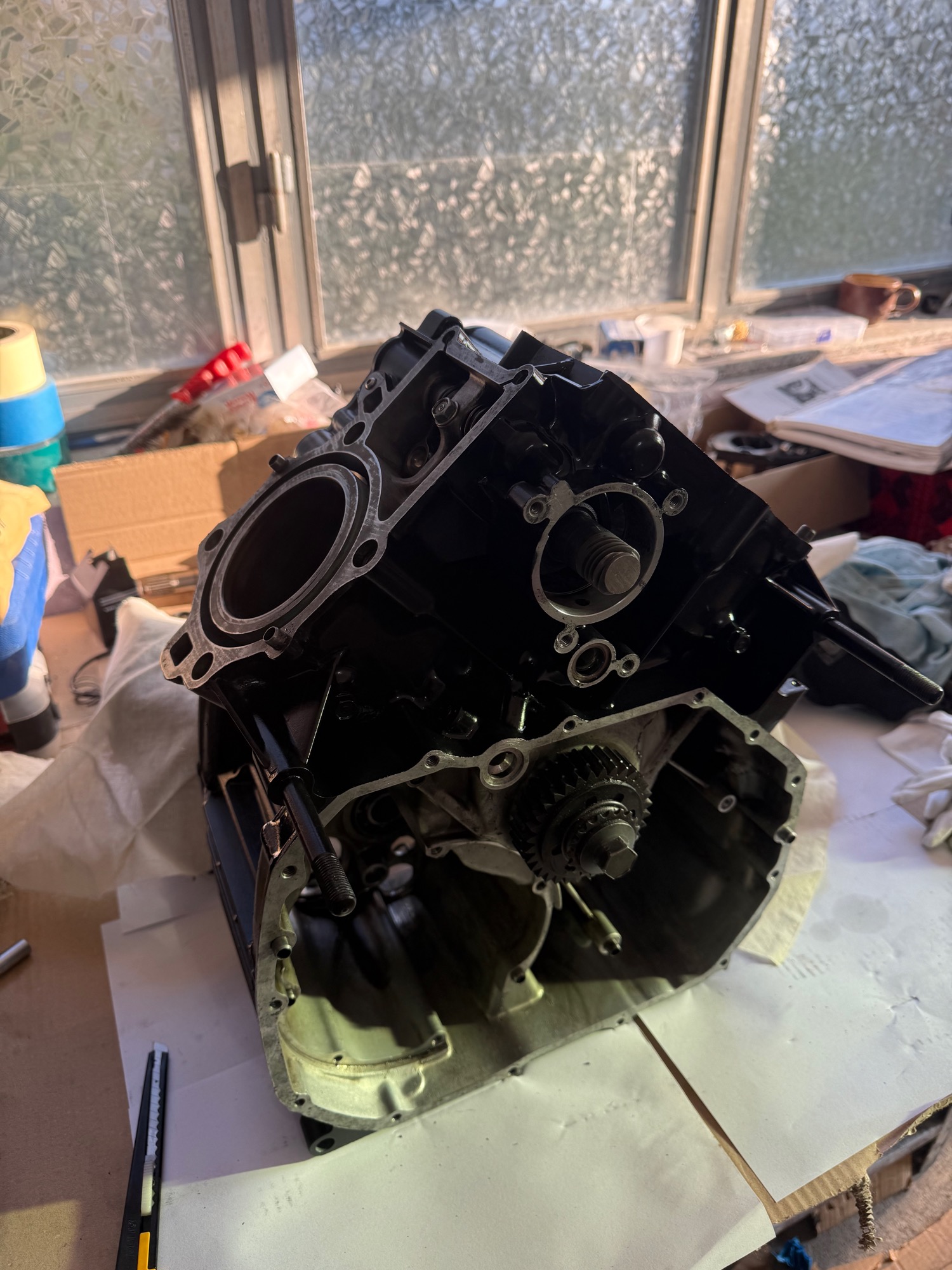 Honda CX500 parts laid out on workbench for rebuild